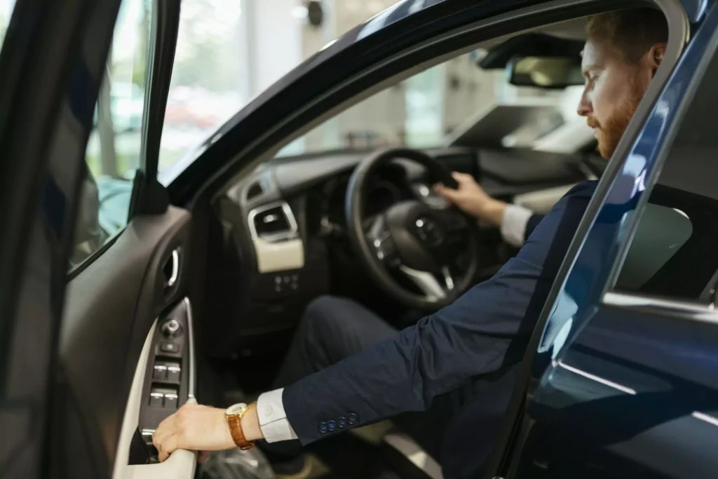 businessman testing car in car dealership royalty free image 1588613103 6606a2b02d41a